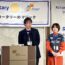 壇上で話す加藤と、隣に立つ実里